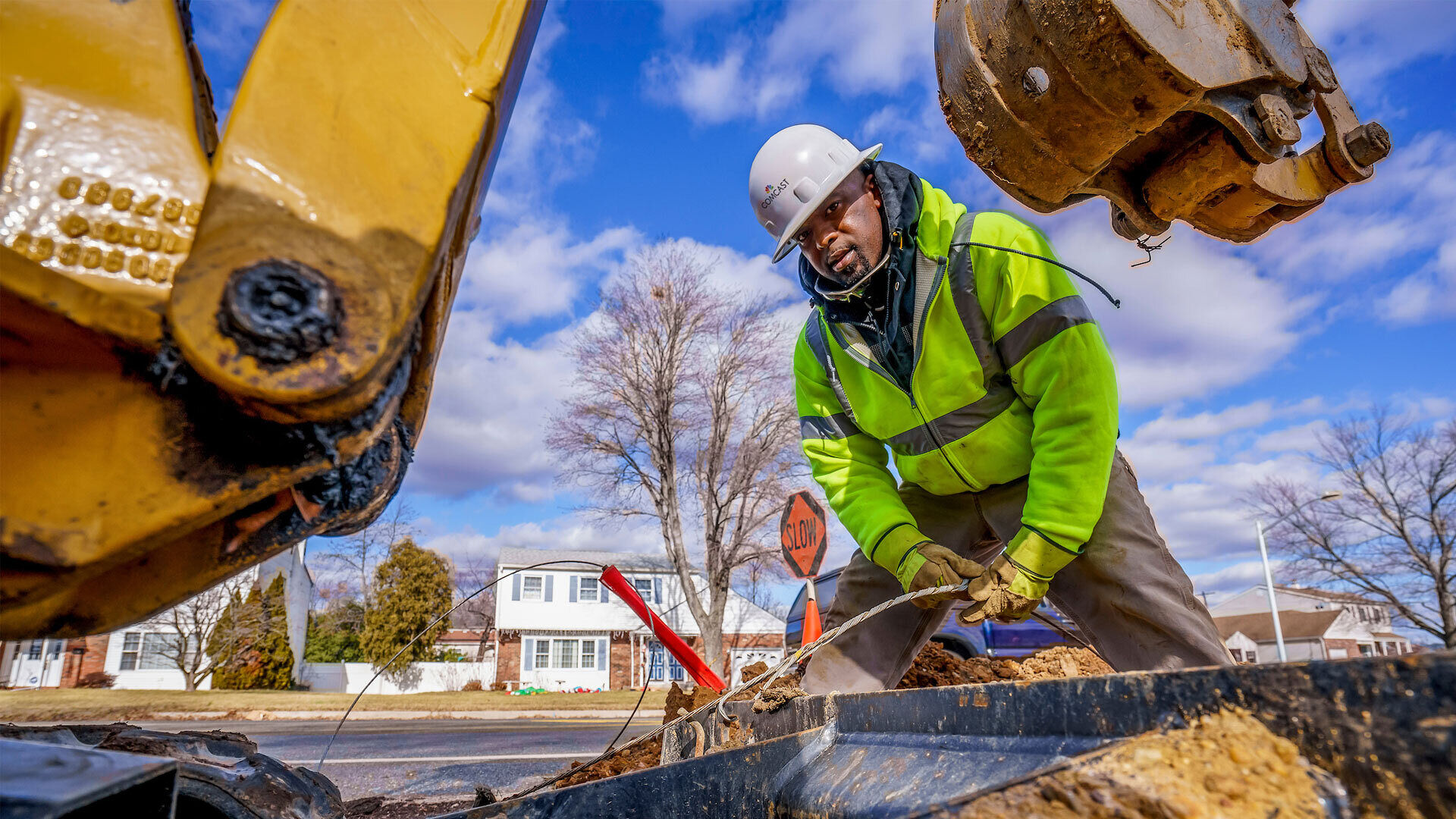 A technician uses heavy machinery to fix a cable