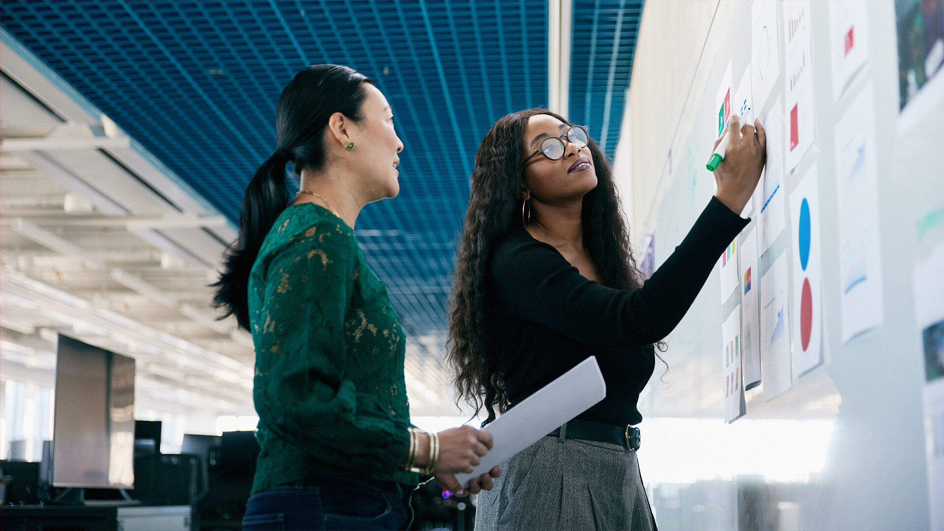 Technology teammates work at a whiteboard